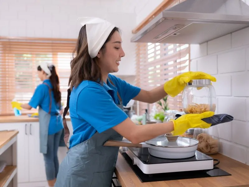 Portrait of young asian woman cleaning in the kitchen at home Portrait of young asian woman cleaning in the kitchen at home